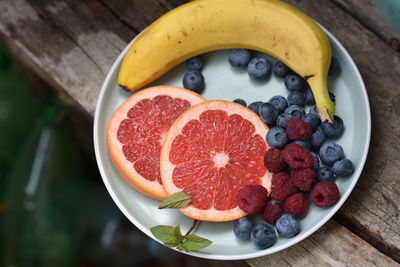 High angle view of chopped fruits in bowl on table