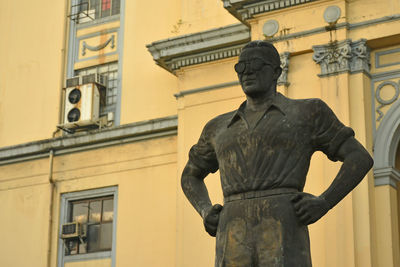 Low angle view of statue against historic building