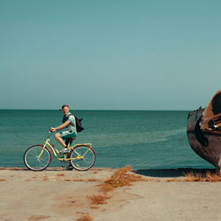 Bicycle on beach against clear sky