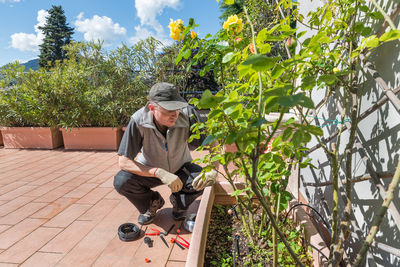 High angle view of man working by plant outdoors