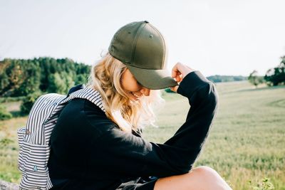 Midsection of woman sitting on field