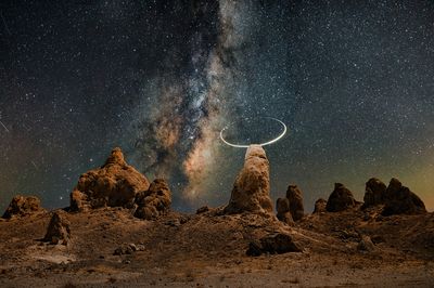 Rock formations against sky at night