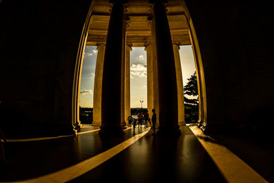 Silhouette people in corridor of building