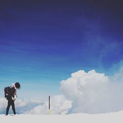 Low angle view of man standing against sky