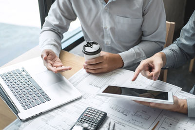 High angle view of man using smart phone on table