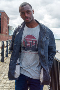 Portrait of young man standing at beach