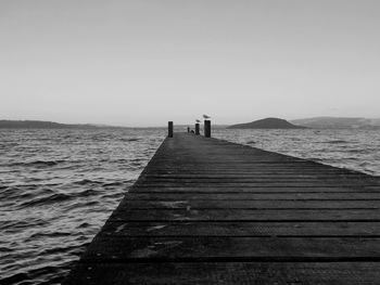 Pier over sea against clear sky