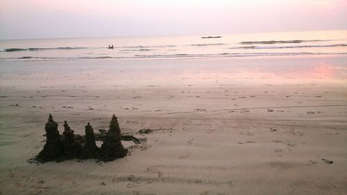 Scenic view of beach against sky during sunset