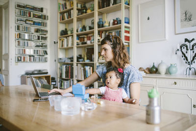 Women sitting on table at home