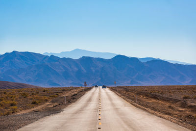 Road amidst mountains against sky