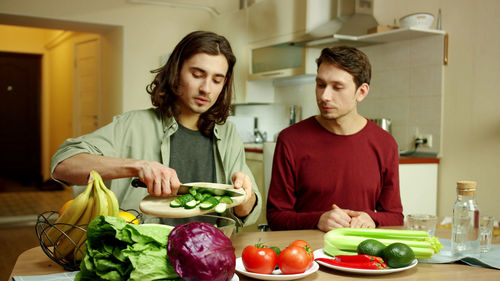 Young couple preparing food in kitchen at home