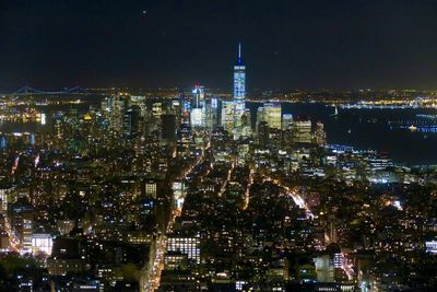 Aerial view of city lit up at night