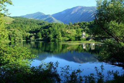 Scenic view of lake and mountains against sky