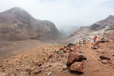 Hiker on mountain against sky