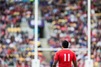 Rear view of a man sitting on floor