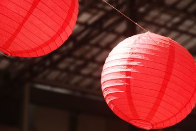 Low angle view of illuminated lanterns hanging from ceiling