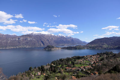 Scenic view of sea and mountains against sky