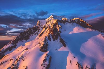Scenic view of snow covered mt hood against sky at sunset