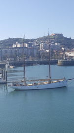 Boats sailing on river in city