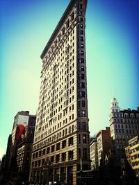 Low angle view of buildings against clear blue sky