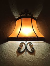 Close-up of illuminated lamp on wall