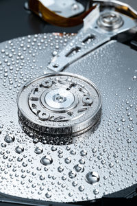 Close-up of water drops on metal