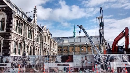 Low angle view of building against cloudy sky