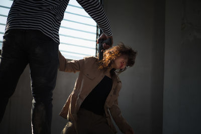 Midsection of couple standing at home