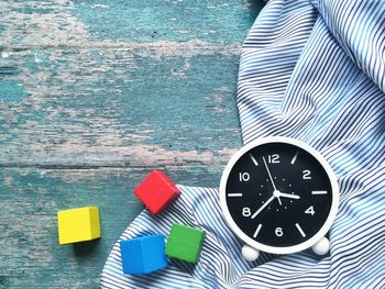 High angle view of clock on table against wall