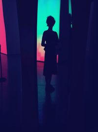 Blurred motion of woman in dark room