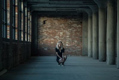Full length portrait of woman in abandoned building