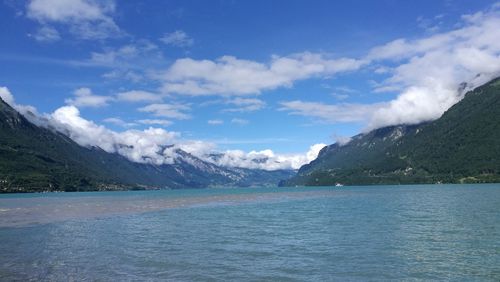 Scenic view of sea and mountains against sky