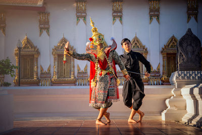 People at temple outside building