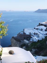 High angle view of buildings by sea against sky