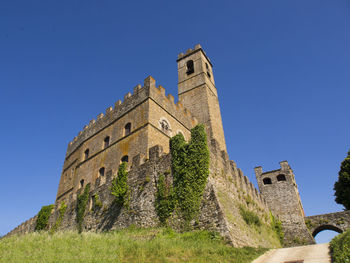 Low angle view of historic building against clear blue sky