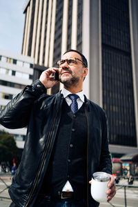 Man using mobile phone in city