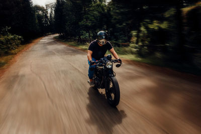 Man riding motorcycle on road