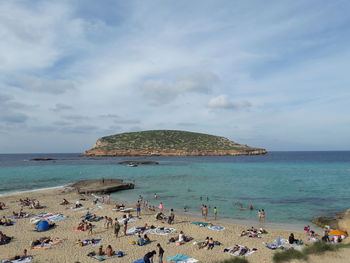 People on beach against sky