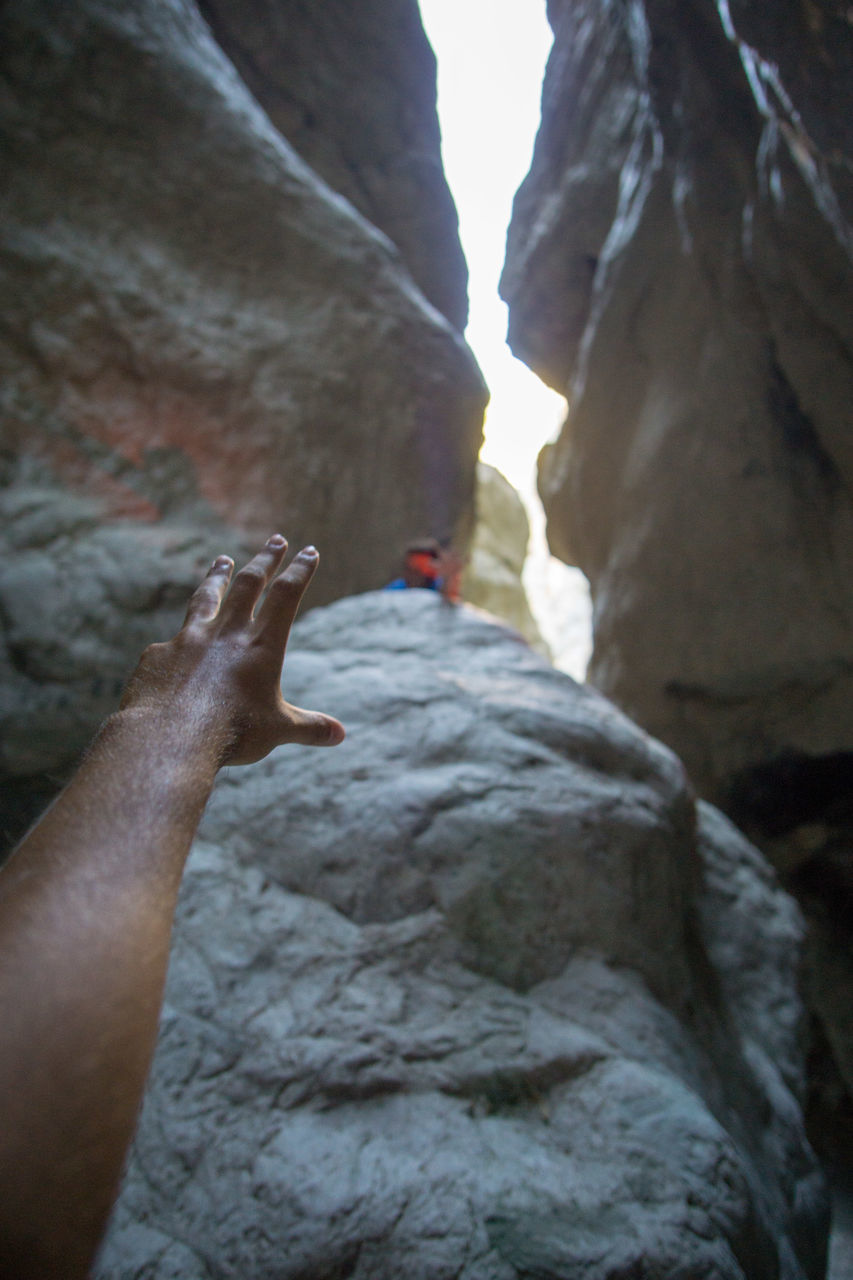 CLOSE-UP OF HANDS ON ROCK