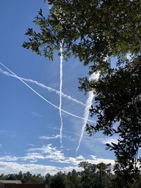 Low angle view of vapor trail against sky