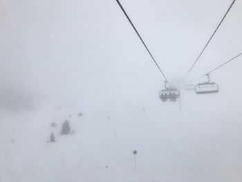 Ski lift over snow covered field