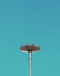 Low angle view of street light against blue sky