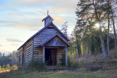 Abandoned built structure on field against sky