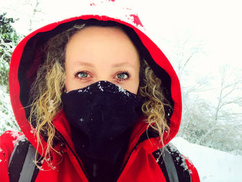 Portrait of woman with red face covered with snow