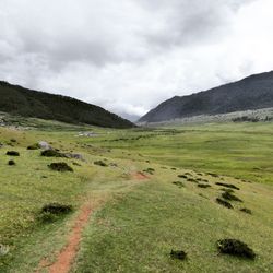 Scenic view of landscape and mountains against sky