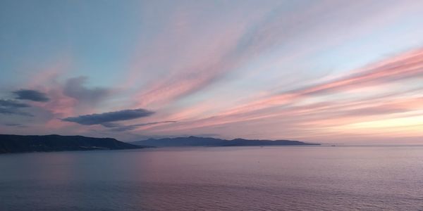 Scenic view of sea against romantic sky at sunset