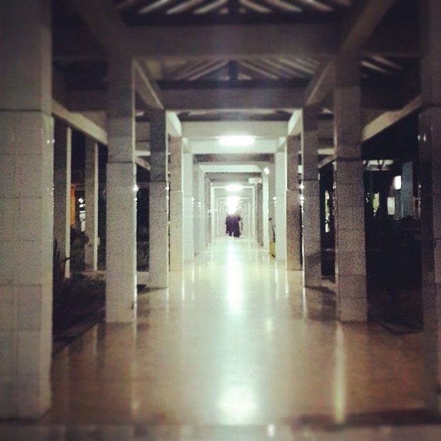 indoors, architecture, built structure, corridor, silhouette, men, walking, the way forward, lifestyles, reflection, architectural column, flooring, ceiling, building, person, full length, unrecognizable person, diminishing perspective, illuminated