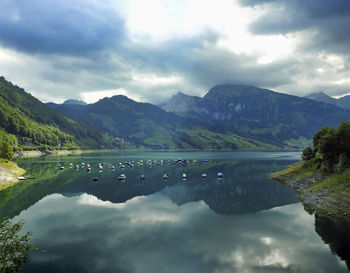 Scenic view of lake and mountains against sky