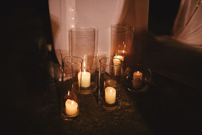 Burning candles oncandlestick against dark background at home. vintage style. calm romantic 
