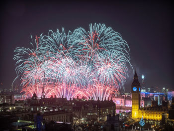 High angle view of firework display at night